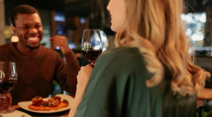 A couple is enjoying dinner at a restaurant. (Generated with AI)