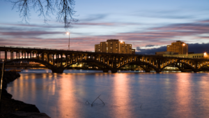 Skyline view of Rockford with water and a bridge in the foreground.