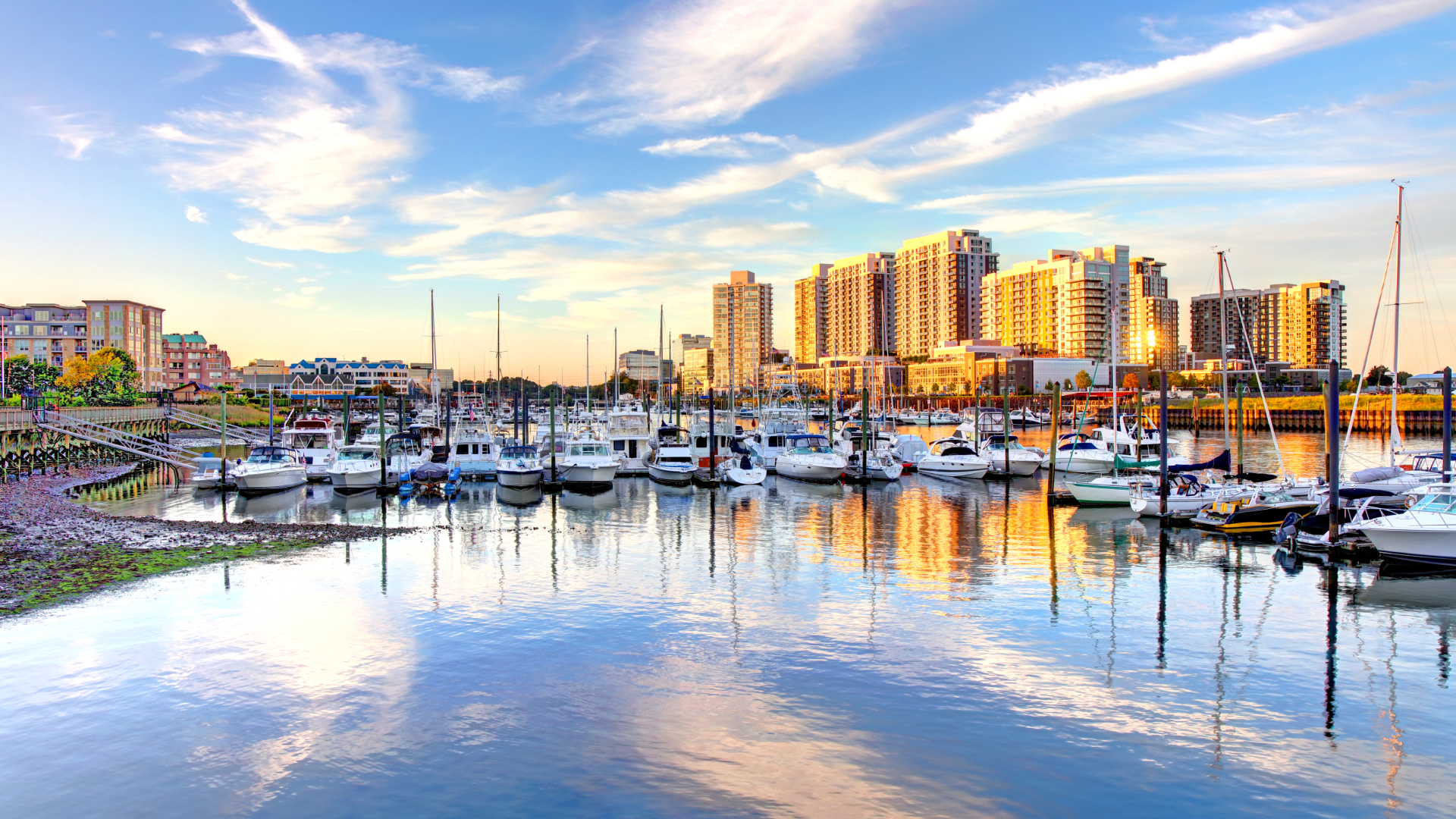 City skyline of Stamford next to the water with boats.