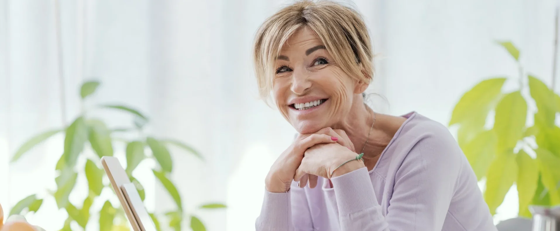 Smiling mature woman sitting at a breakfast table