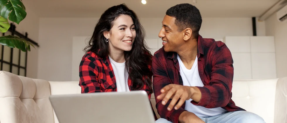 A couple sitting on the couch having a conversation