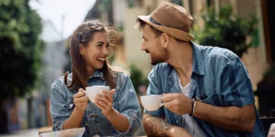 A couple drinking a cup of cofee together in the public.