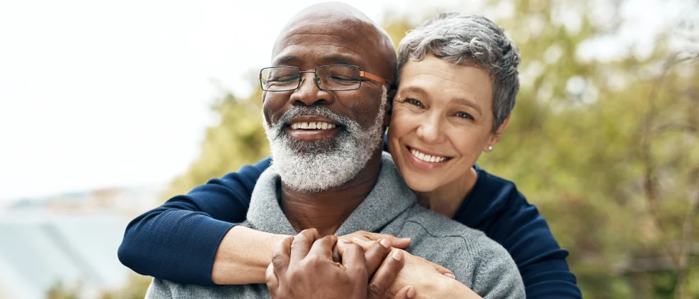 Happy couple hugging in a park